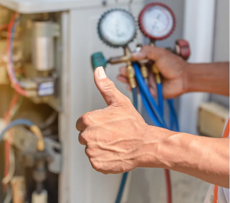 full-serv-hvac Hand giving thumbs up near HVAC gauges, indicating successful air conditioning maintenance or repair.